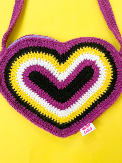 Close view of a non binary flag bag shaped like a heart showing the crochet stitches.