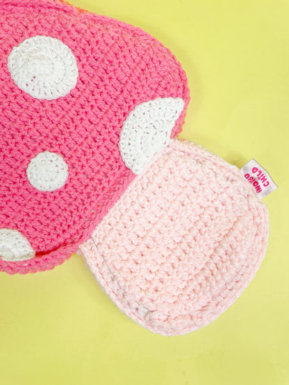 Close view of the bottom of a pink mushroom bag with an Indigo Child label sewn into the side.